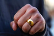 Mano de hombre con gran anillo de oro.