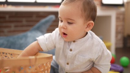 Poster - Adorable toddler holding ball of wicker basket at kindergarten