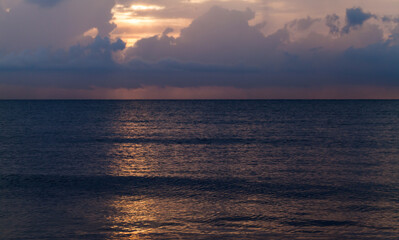 Wall Mural - dark sky over calm ocean at sunset, natural photo
