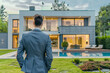 © Dreams Studio™ - Confident successful man standing in front of his new modern house, businessman buying his dream house, back view, Concept of real estate