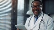 © MP Studio - A Smiling Doctor Holding Tablet