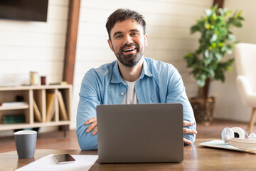 Aufkleber - A man is seated in front of a laptop computer, typing on the keyboard and staring at the screen. He appears focused and engrossed in his work.