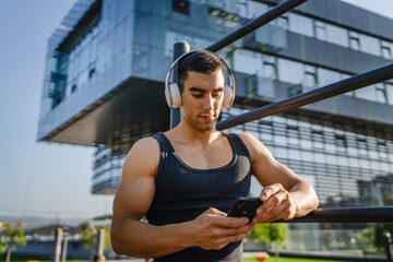 Poster - man young male use mobile phone at outdoor open training park gym