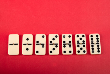 Wall Mural - Dominoes with red background, copy space and various angles