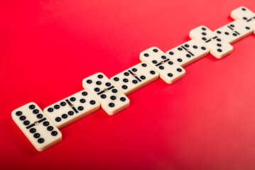 Wall Mural - Dominoes on a red background.