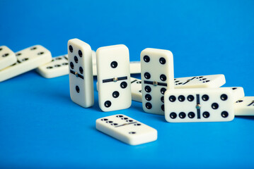 Wall Mural - Dominoes with blue background, copy space and various angles.