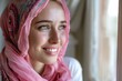Smiling Woman in Pink Headscarf by Window, with Soft Focus Background