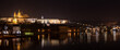 Illuminated Hradcany (Prague Castle)  and Charles Bridge,  St. Vitus Cathedral and St. George church, medieval architecture, Vltava river at night, Bohemia, Czech Republic.