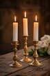 Elegant Wedding Table Centerpiece: Two Tiered Candle Stands with Gold Candlesticks and White Candles on Wooden Table