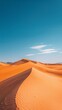 Stunning Orange Sand Dunes Under Clear Blue Sky
