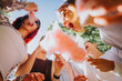 © qunica.com - A lively group of friends share moments of joy and laughter while enjoying cotton candy in a sunny park, embodying a true sense of togetherness and fun.