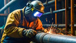 Industrial worker with protective mask welding steel pipe in the factory