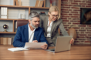 Confident man and woman discussing on psychological assistance using laptop