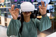 © Wavebreak Media - At office, biracial businesswoman wearing virtual reality headset working late
