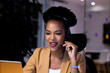 © Wavebreak Media - African American businesswoman in headset speaks to laptop, working late