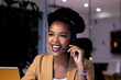 © Wavebreak Media - Working late at office, African American businesswoman wearing headset