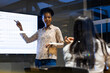 © Wavebreak Media - Diverse female colleagues presenting at office, working late