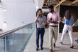 © Wavebreak Media - Diverse office team at office, walking and talking, wearing casual attire