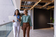 © Wavebreak Media - Diverse office team and biracial woman in blue talk laptop content while walking, copy space