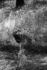 Wall Mural - Tactical armored helmet with MultiCam color visor on the ground in the forest.
Military themes, protection of life.
War in Ukraine
Black and white photo