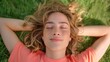 © Multiverse - A girl is laying in the grass with her eyes closed, enjoying a moment of relaxation in nature