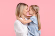 © New Africa - Family portrait of happy mother and daughter on pink background