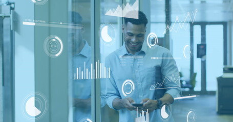 Wall Mural - Image of statistical data processing against biracial man using smartphone smiling at office