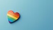 Rainbow-colored heart on blue background, symbolizing inclusivity and love