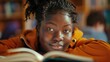 Inclusive image of a happy female african american pupil studying at school. University student studying and revising for exams. Diversity and ethnic minority representation at college.