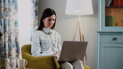 A young business woman working at home. Remote job employee. Irritated businesswoman close notebook when realize her project lost. Confused female programmer accidentally turned off program