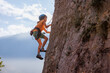 © zhukovvvlad - rock climber boy. child is practicing rock climbing. summer camp. sport in nature. cute teenager climbing on a rock with belay