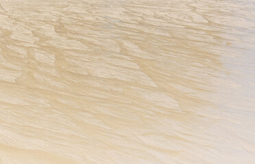 Wall Mural - White sand on the seashore as an abstract background. Texture