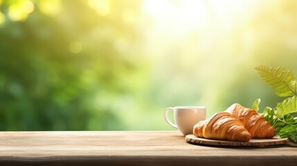 A plate of croissants and a cup of coffee on a wooden table