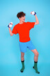 Fitness and healthy lifestyle. Retro style. A young attractive man goes in for sports. Blue background.