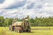 Tractor driving on a field and fertilizing