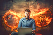 A man sits in front of a laptop, surrounded by a fiery backdrop, hacking into a computer network