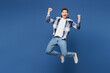 © ViDi Studio - Full body young happy man he wear shirt white t-shirt casual clothes jump high doing winner gesture celebrate clenching fists isolated on plain blue cyan background studio portrait. Lifestyle concept.