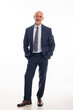 © gzorgz - Full length of mid aged man wearing suit against isolated background