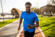 Young african-american man is jogging in the city.