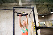 Beautiful sport woman doing suspension training, total resistance exercise. Routine workout for woman's physical and mental health.