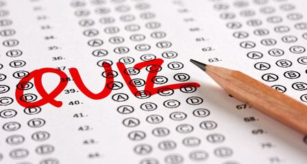 Wall Mural - Close up view of a test exam paper with the word quiz and a pencil.