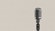 Retro style vintage microphone against white textured wall background.