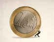 © Westend61 - Businessman getting crushed under oversized one euro coin