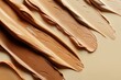 A closeup of the texture and color tones in different shades of liquid foundation, with visible brush strokes. This is suitable as a backdrop or wallpaper for beauty product promotional material.