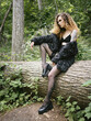 Portrait of young woman in a fur coat in the forest. Natural light.