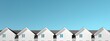 © Usman - A row of identical white houses under a clear sky.
