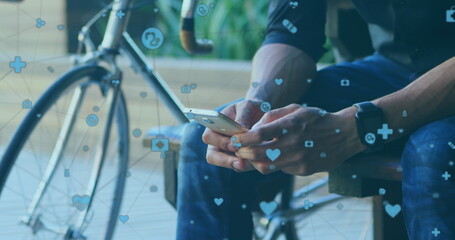 Wall Mural - Biracial young professional holding smartphone, sitting near bike