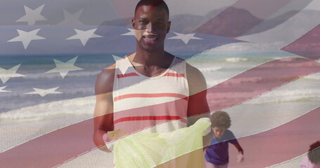 Wall Mural - Image of flag of united states of america over happy african american father and son on beach