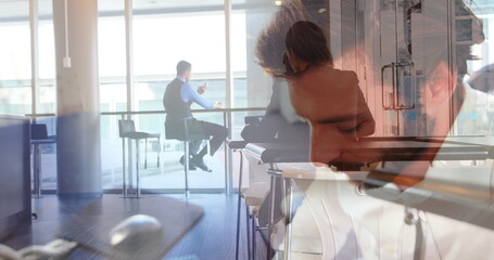 Wall Mural - Image of caucasian man using computer over business people in office