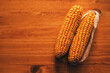 Harvested ear of corn on wooden background
